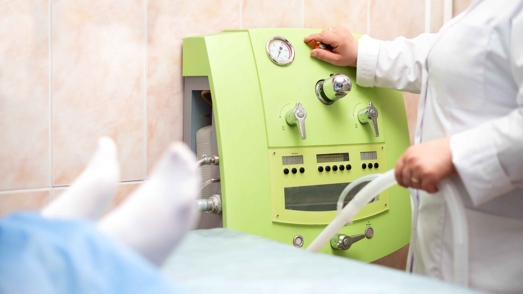 Therapist operating the colon hydrotherapy machine at HealthSphere & Wellness